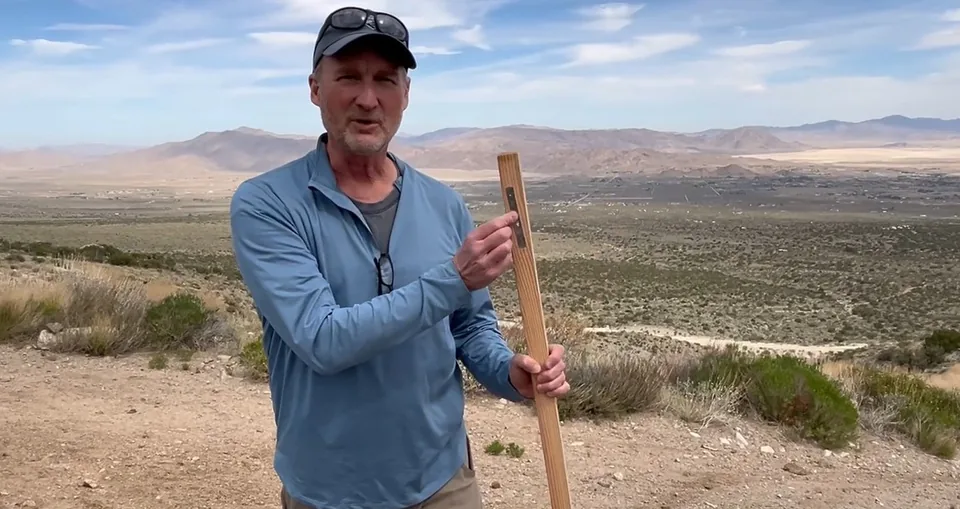 Jeff Janda holding a claim stake in the Nevada desert